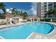 Relaxing community pool area with cabanas and lounge chairs at 401 N Point Rd # 901, Osprey, FL 34229