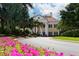 The Oaks Club's grand clubhouse with manicured landscaping and a curving driveway at 401 N Point Rd # 901, Osprey, FL 34229