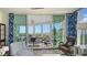 Living room with sliding glass doors showcasing a balcony and scenic waterfront view at 401 N Point Rd # 901, Osprey, FL 34229