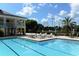 Resort-style pool with lounge chairs, close to the clubhouse at 401 N Point Rd # 901, Osprey, FL 34229