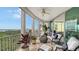 Spacious screened balcony with water views, comfortable seating, and lush plants at 401 N Point Rd # 901, Osprey, FL 34229