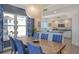 Elegant dining room with a large wooden table and blue chairs at 401 N Point Rd # 901, Osprey, FL 34229