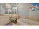 Bathroom with a large soaking tub and double vanity at 401 N Point Rd # 901, Osprey, FL 34229
