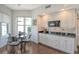 Eat-in kitchen with white cabinets, granite counters, and a breakfast area at 401 N Point Rd # 901, Osprey, FL 34229