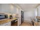 Modern kitchen with granite countertops and white cabinets at 5400 Ocean Blvd # 6-4, Sarasota, FL 34242