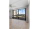 Living room with tiled floors, ceiling fan, and panoramic windows offering city views at 5400 Ocean Blvd # 6-4, Sarasota, FL 34242
