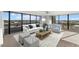 Bright living room with ocean view, comfy seating, and large windows at 5400 Ocean Blvd # 6-4, Sarasota, FL 34242