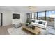 Living room with large windows, comfortable seating and city views at 5400 Ocean Blvd # 6-4, Sarasota, FL 34242
