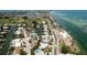 Aerial view showing a home's location in a waterfront community with lush landscaping and canals at 676 Key Royale Drive, Holmes Beach, FL 34217