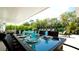 Outdoor patio furniture with a view of the pool and lush landscaping at 676 Key Royale Drive, Holmes Beach, FL 34217