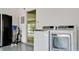 Bright laundry room with washer, dryer, and extra storage at 676 Key Royale Drive, Holmes Beach, FL 34217