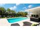 Inviting pool with multiple lounge chairs and a grassy backyard at 676 Key Royale Drive, Holmes Beach, FL 34217