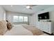 Bedroom with king-size bed, dresser, and large windows offering natural light at 676 Key Royale Drive, Holmes Beach, FL 34217