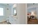 Clean bathroom with a single vanity, view to bedroom, and modern fixtures at 676 Key Royale Drive, Holmes Beach, FL 34217