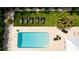 High-angle view of a pristine pool and surrounding patio at 676 Key Royale Drive, Holmes Beach, FL 34217