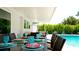 Relaxing poolside patio with a dining table and comfortable seating at 676 Key Royale Drive, Holmes Beach, FL 34217