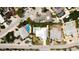 Aerial view of a home with a pool and lush landscaping in a quiet residential neighborhood at 676 Key Royale Drive, Holmes Beach, FL 34217