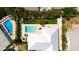 Aerial view showcasing a home with a large pool and lush tropical landscaping at 676 Key Royale Drive, Holmes Beach, FL 34217
