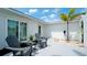 Inviting front patio with two gray adirondack chairs, perfect for relaxing at 676 Key Royale Drive, Holmes Beach, FL 34217