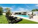 Stunning pool area with lounge chairs and a lush green lawn at 676 Key Royale Drive, Holmes Beach, FL 34217