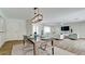 Bright dining room features a modern table, chairs, and stylish light fixture at 676 Key Royale Drive, Holmes Beach, FL 34217