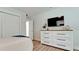 Spacious bedroom with a dresser, closet, and a mounted TV at 676 Key Royale Drive, Holmes Beach, FL 34217