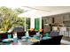 Spacious outdoor patio with dining table and chairs, offering views of the kitchen and backyard at 676 Key Royale Drive, Holmes Beach, FL 34217