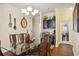 Formal dining room with glass table, dark wood chairs, and decorative wall clock at 27855 Arrowhead Cir, Punta Gorda, FL 33982