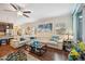 Open living area features a large sectional sofa, wood floors, and a cozy atmosphere at 27855 Arrowhead Cir, Punta Gorda, FL 33982