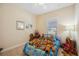 Charming bedroom with a Scooby Doo themed bedspread and numerous stuffed animals at 27855 Arrowhead Cir, Punta Gorda, FL 33982