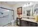 Clean bathroom with granite vanity, tiled shower, and modern fixtures at 27855 Arrowhead Cir, Punta Gorda, FL 33982