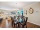 Bright dining room featuring a glass table and six chairs, hardwood floors, and decorative wall art at 27855 Arrowhead Cir, Punta Gorda, FL 33982