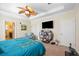 Main bedroom with king bed, TV, and access to bathroom at 27855 Arrowhead Cir, Punta Gorda, FL 33982