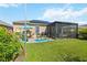 Large backyard with patio, lanai, and solar panels at 27855 Arrowhead Cir, Punta Gorda, FL 33982