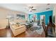 Bright living room boasts a sectional sofa, wood floors, and a stunning peacock rug at 27855 Arrowhead Cir, Punta Gorda, FL 33982