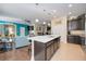 Modern kitchen features dark wood cabinets, an island with white countertop, and stainless steel appliances at 27855 Arrowhead Cir, Punta Gorda, FL 33982