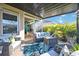 Covered patio with wicker furniture and a tropical rug at 27855 Arrowhead Cir, Punta Gorda, FL 33982