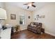 Home office with hardwood floors, desk, and comfortable couch at 27855 Arrowhead Cir, Punta Gorda, FL 33982
