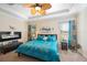 Spacious main bedroom with a king-size bed, fireplace, and large windows at 27855 Arrowhead Cir, Punta Gorda, FL 33982
