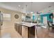 Open kitchen with island, stainless steel appliances, and dark wood cabinets at 27855 Arrowhead Cir, Punta Gorda, FL 33982