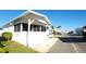 White single-wide manufactured home with carport and screened porch at 3333 26Th E Ave # 1064, Bradenton, FL 34208