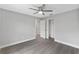 Bedroom with ceiling fan and grey wood-look floors at 214 Lime Tree Park, Rotonda West, FL 33947