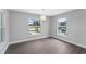 Bright dining room with wood-look floors and large windows offering pool view at 214 Lime Tree Park, Rotonda West, FL 33947