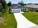 New construction home with driveway and grassy lawn at 214 Lime Tree Park, Rotonda West, FL 33947
