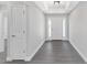 Bright entryway with white trim and grey wood-look floors at 214 Lime Tree Park, Rotonda West, FL 33947