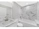 Bathroom with white marble-look tiled shower and bathtub at 214 Lime Tree Park, Rotonda West, FL 33947
