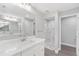 Modern bathroom with double vanity, marble shower, and updated finishes at 214 Lime Tree Park, Rotonda West, FL 33947