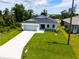 Property view showcasing home's curb appeal and landscaping at 214 Lime Tree Park, Rotonda West, FL 33947
