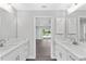 Modern bathroom with double vanity, marble shower, and updated finishes at 214 Lime Tree Park, Rotonda West, FL 33947