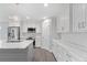 Modern kitchen with white cabinets and large island at 214 Lime Tree Park, Rotonda West, FL 33947